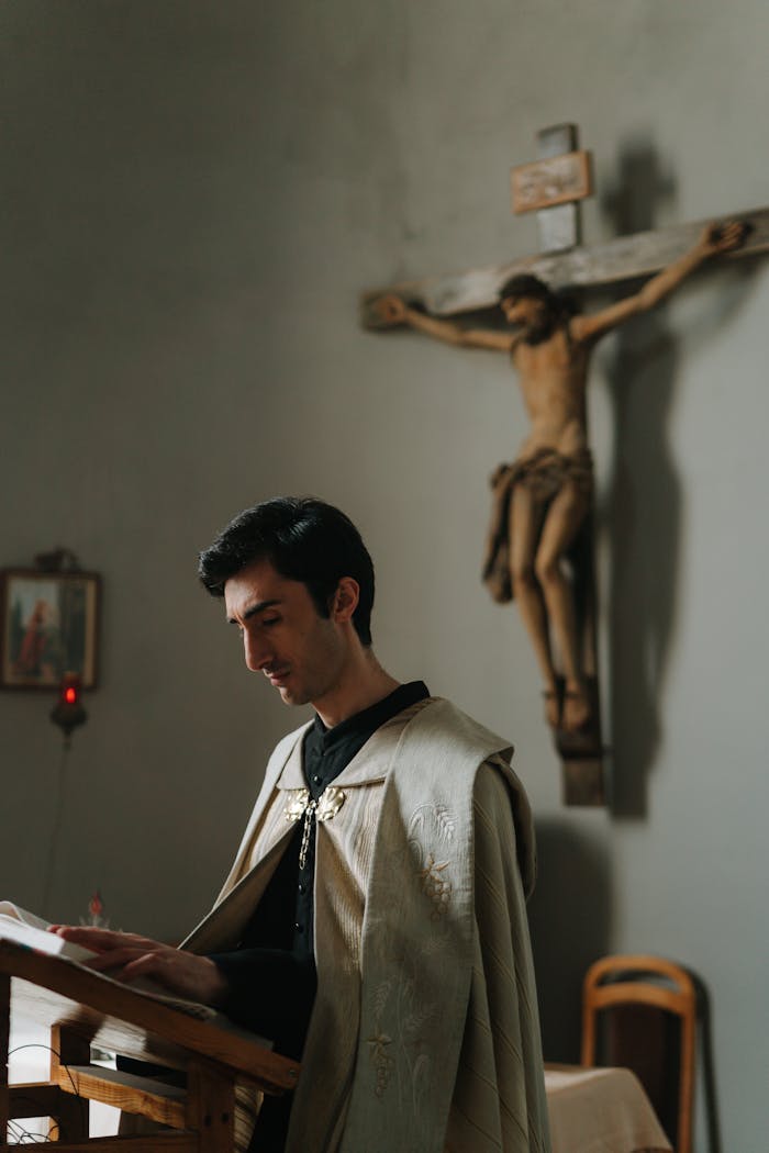 ours-journey A priest reads religious scriptures at a church altar, with a wooden crucifix in the background.